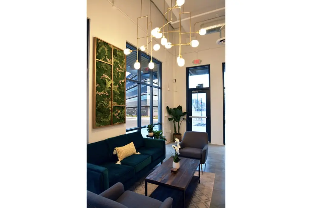 Retail lounge area in northern Indiana with sofa seating, modern lighting, and welcoming entry design