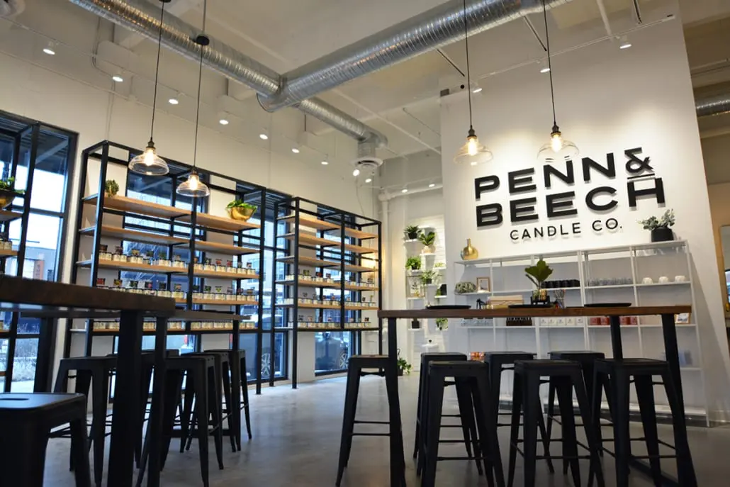 Modern retail store interior in Carmel, Indiana with product displays, shelving, and communal tables