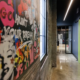 Creative office corridor in Greenwood Indiana with graffiti wall, glass doors, and polished concrete floors