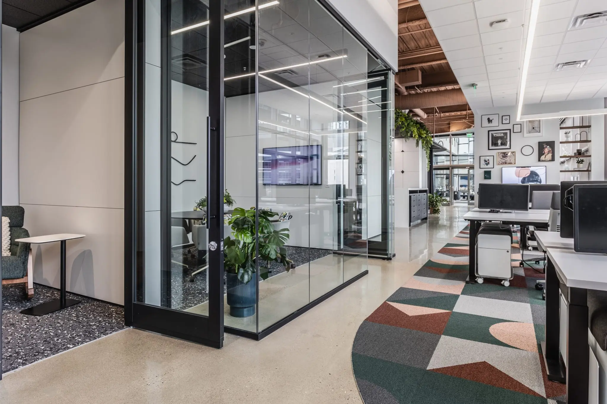 Open office design in Indianapolis with glass conference room, modern workstations, and collaborative layout