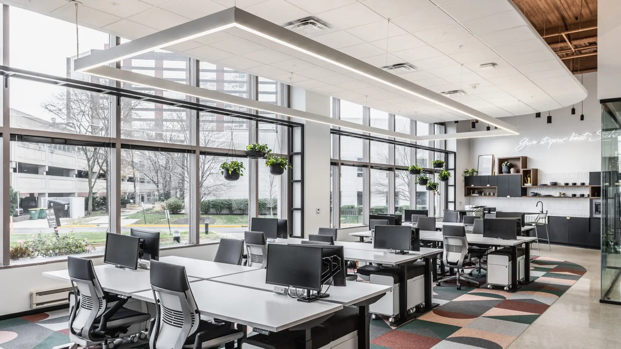 Open office workstations in northern Indiana with large windows, natural light, and flexible desk layout