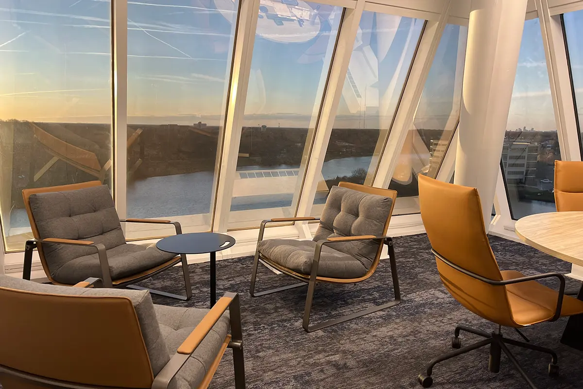 Modern office lounge seating area with floor to ceiling windows and river view in Indianapolis