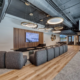 Open office lounge design in northern Indiana with soft seating, wood accents, and modern lighting fixtures