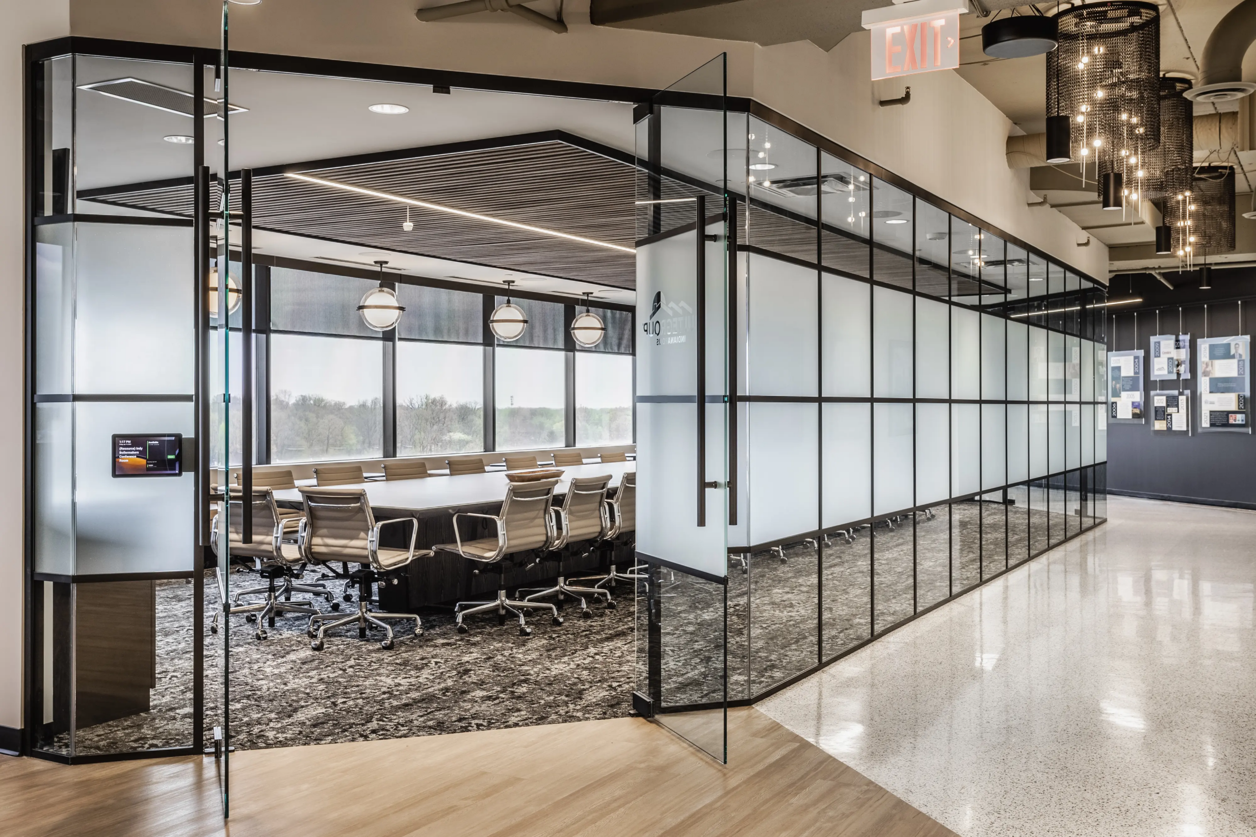 Glass-walled conference room with modern office design and collaborative meeting space at Pulte Carmel, Indiana
