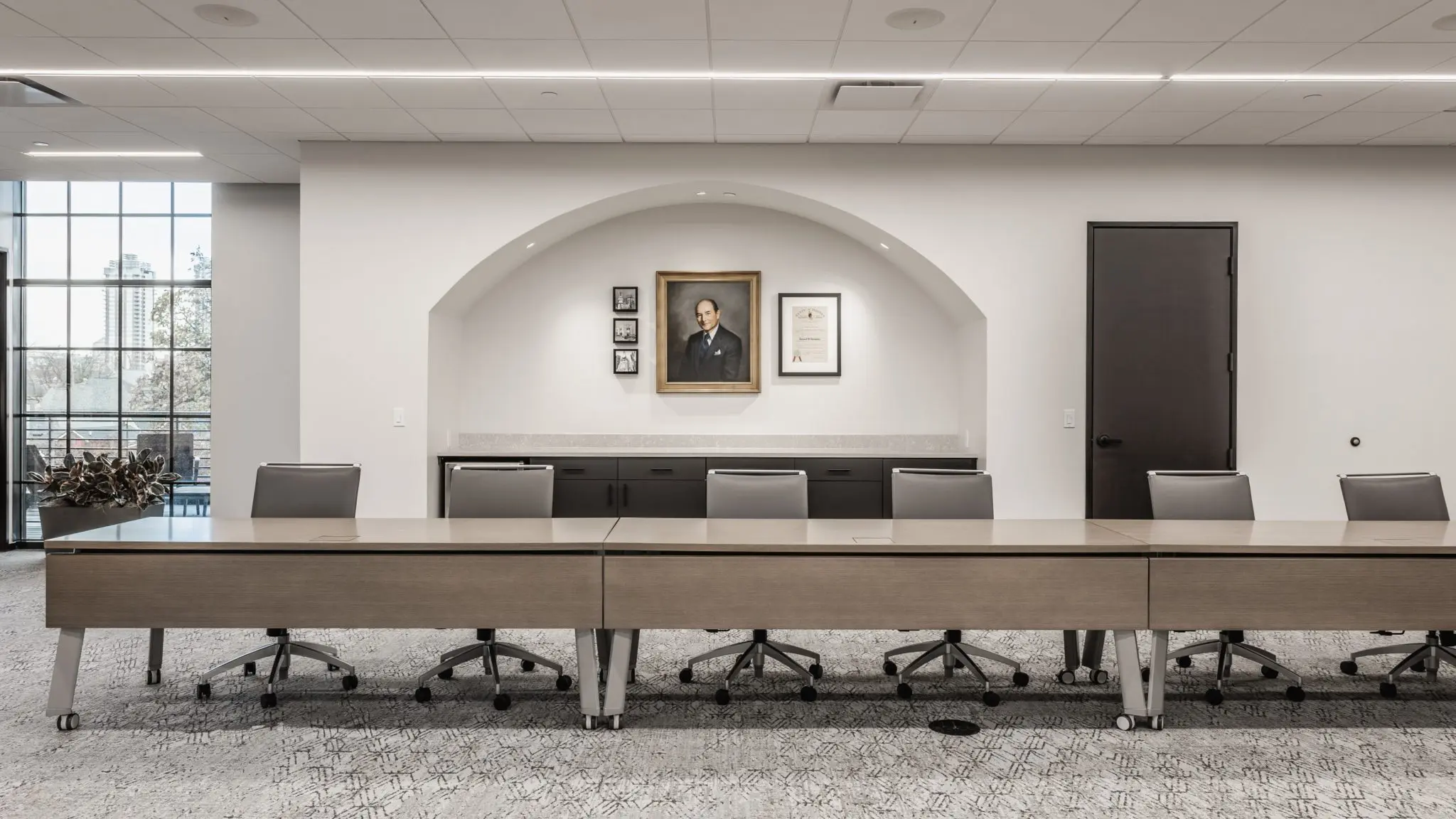 Boardroom design in central Indiana with long conference table, neutral finishes, and built-in storage