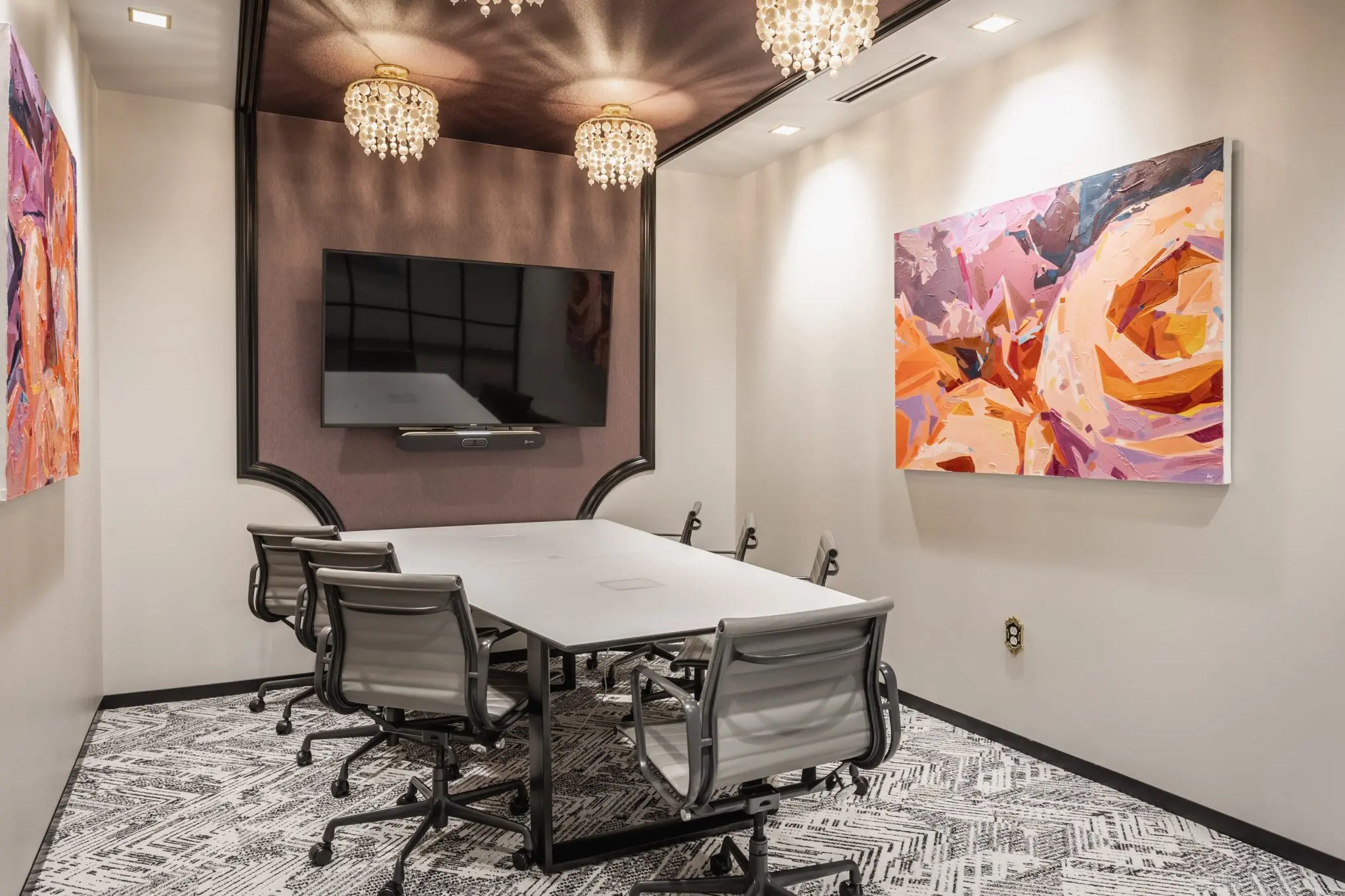 Conference room in Fishers, Indiana with statement lighting, meeting table, and contemporary finishes