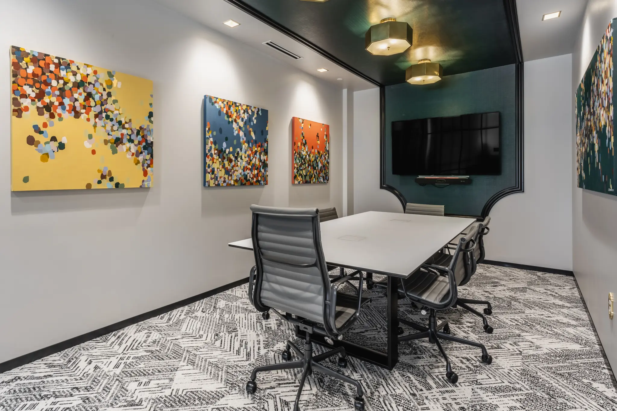 Creative office conference room in northern Indiana with colorful artwork and modern meeting table