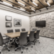 Small conference room in Indianapolis, Indiana with meeting table, wall-mounted screen, and contemporary lighting