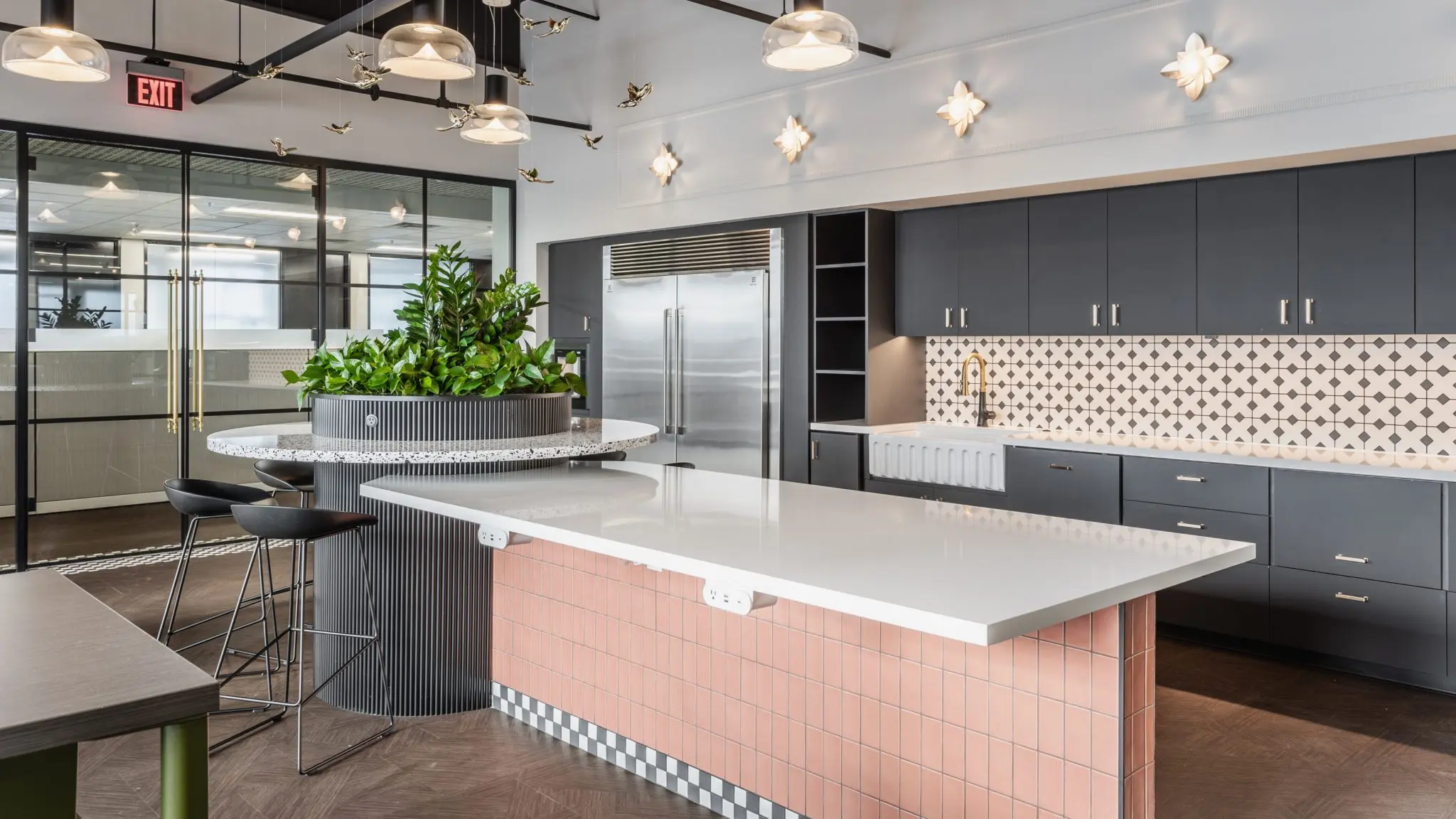 Office kitchen in Fishers, Indiana with large island, tile backsplash, and modern cabinetry