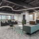 Modern office lobby in Indianapolis with reception desk, lounge seating, and feature lighting