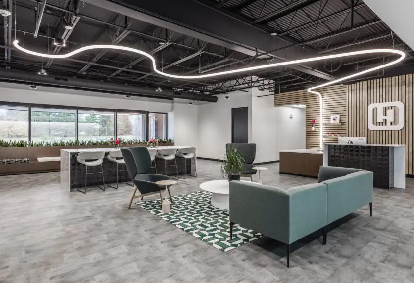 Modern office lobby in Indianapolis with reception desk, lounge seating, and feature lighting