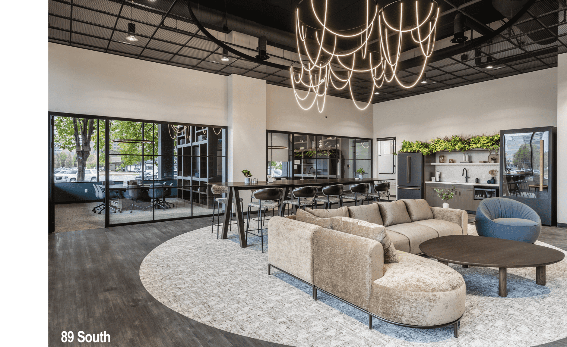Luxury commercial office lounge in Indianapolis with soft seating, greenery, and modern shelving