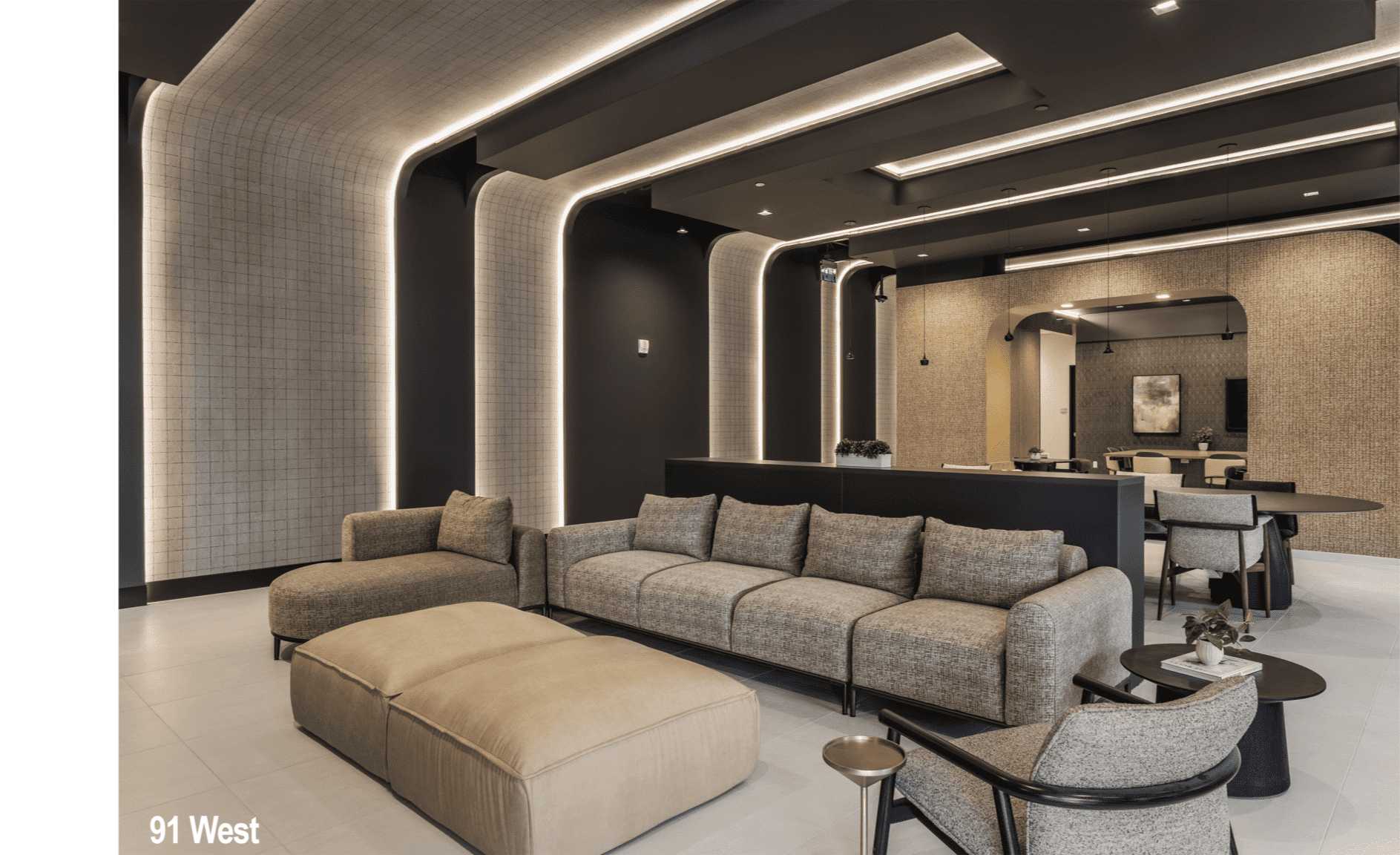 Luxury office lounge in Indianapolis with curved architectural walls, integrated lighting, and modern seating