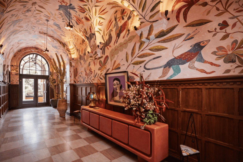 Interior corridor featuring custom mural artwork, wood paneling, and decorative architectural details