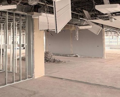 Office demolition phase showing exposed materials and interior systems during commercial renovation