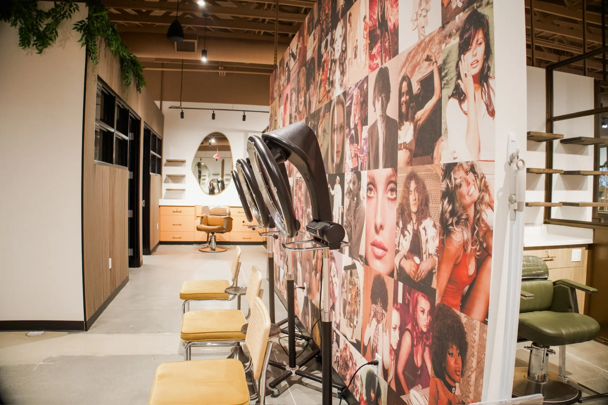 Salon interior in Fishers, Indiana with dryer stations, styling chairs, and feature collage wall