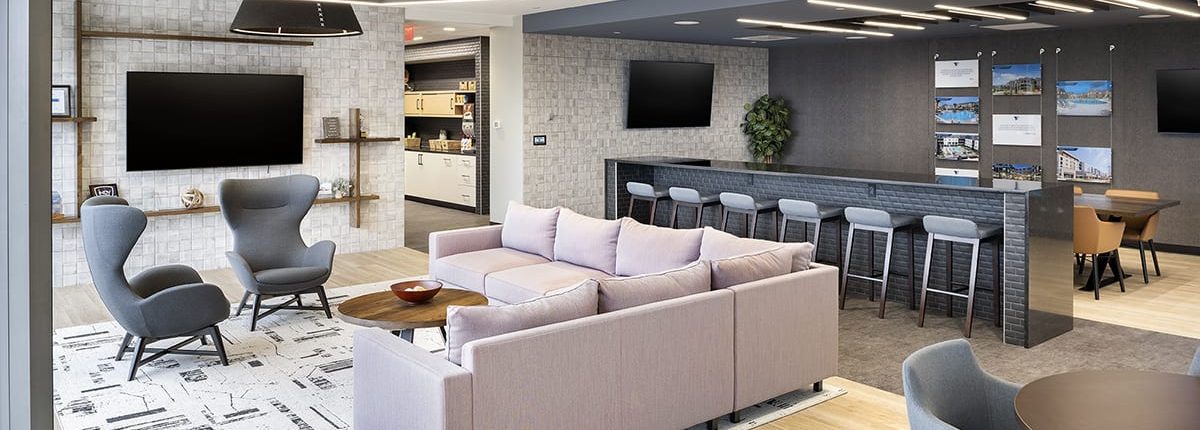 Modern office lounge at Thompson Thrift in Indianapolis featuring collaborative seating, soft finishes, and flexible workspace design.